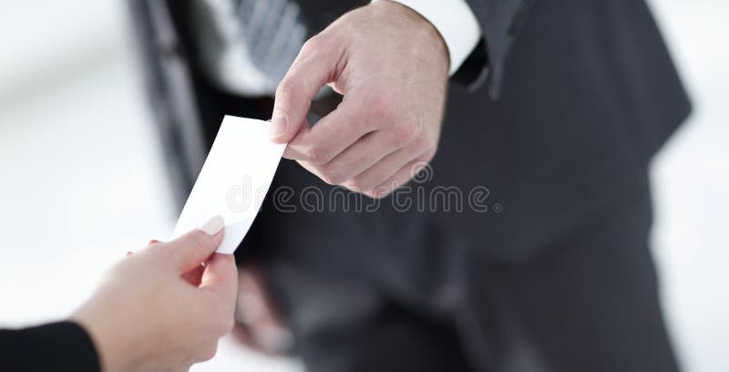 Closeup of businesspeople exchanging business card Stock Photo by BGStock72