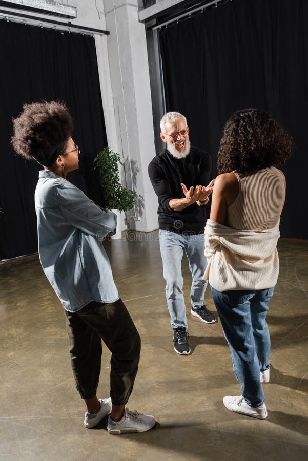Excited bearded producer gesturing and talking stock photography