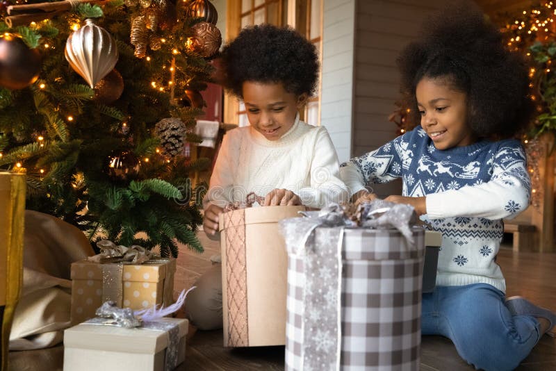 Overjoyed African American family with kids unpacking Christmas gifts Stock  Photo - Alamy