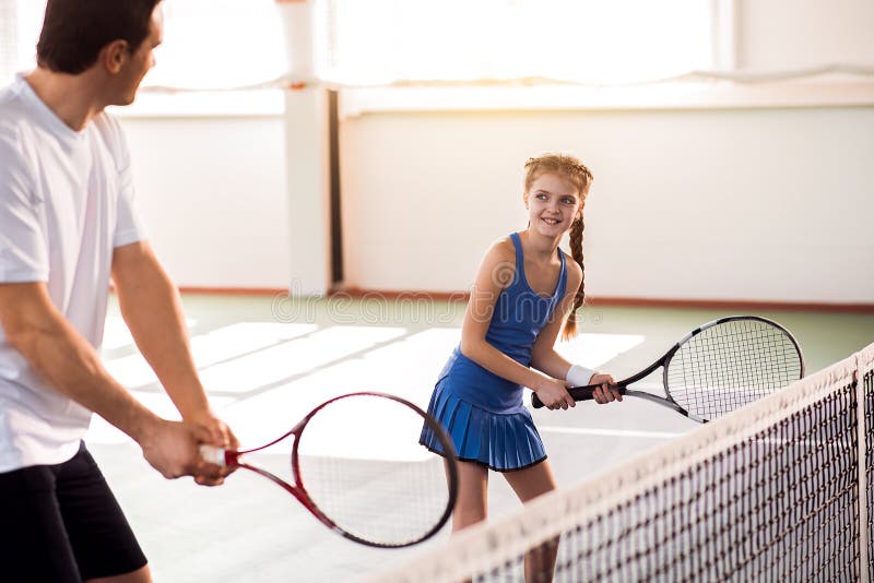 Excited child and dad having fun on tennis court royalty free stock images Excited child and dad having fun on tennis court royalty free stock images