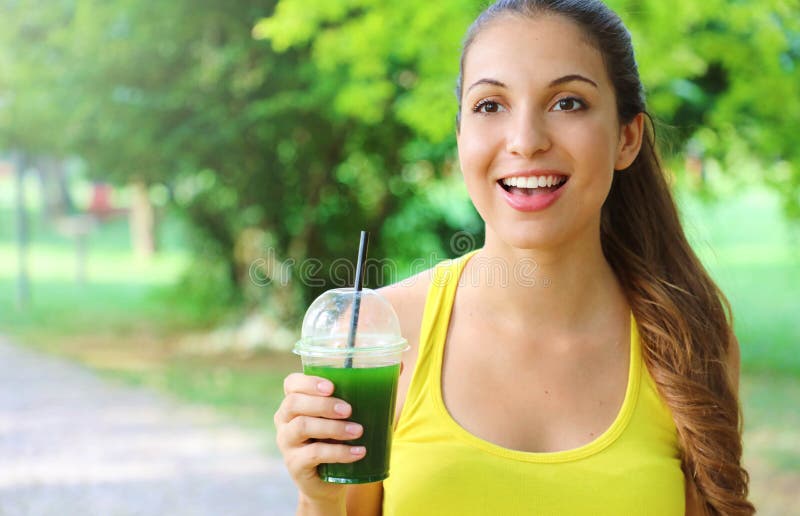 Excited Fitness Woman Holding Green Detox Smoothie And Looking In Front