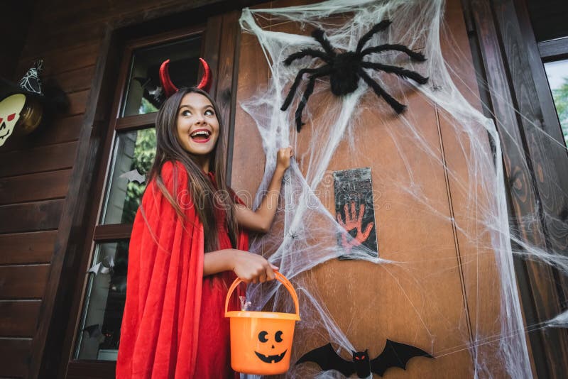 Excited Girl in Devil Costume Knocking Stock Image - Image of outside ...