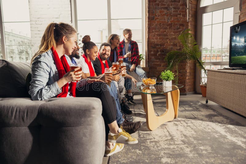 Excited Group Of People Watching Sport Match At Home