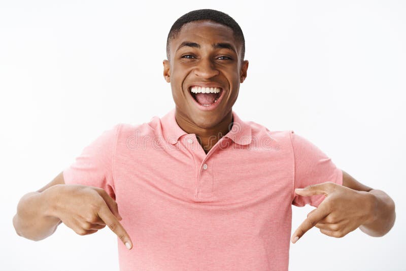 Excited and impressed happy african american man standing high pointing down with amazed and cheerful expression stock photos Excited and impressed happy african american man standing high pointing down with amazed and cheerful expression stock photos