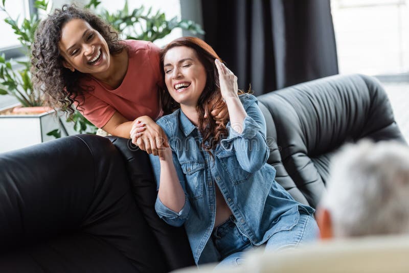 Excited Interracial Lesbian Couple Holding Hands Stock Image Image Of