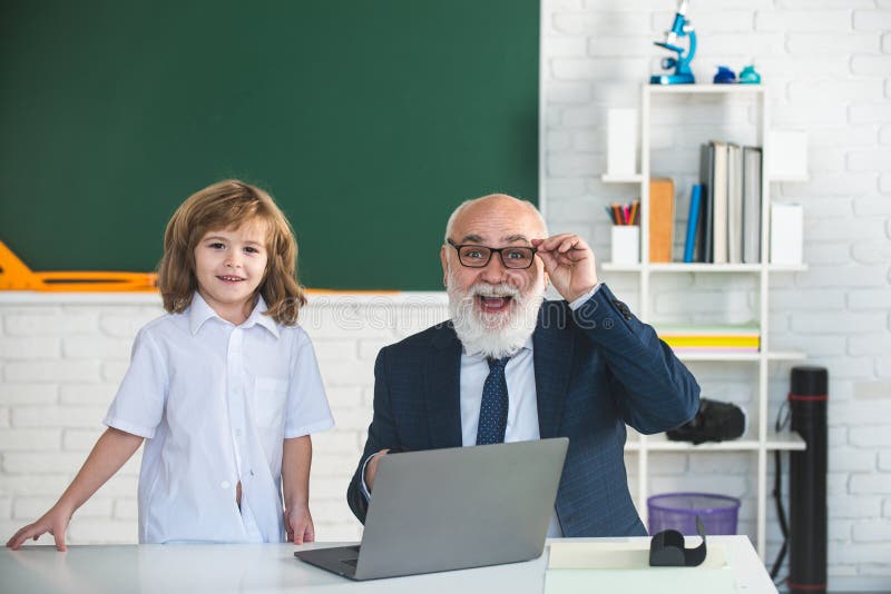 Excited teacher and pupil schoolboy in classroom. Education concept. School learning concept. Boy elementary school. Old royalty free stock photography