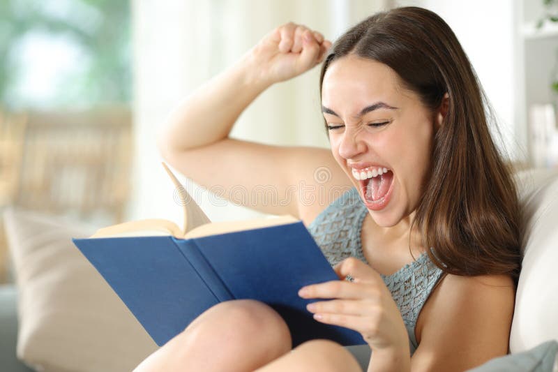 Excited woman celebrating plot twist reading paper book royalty free stock images