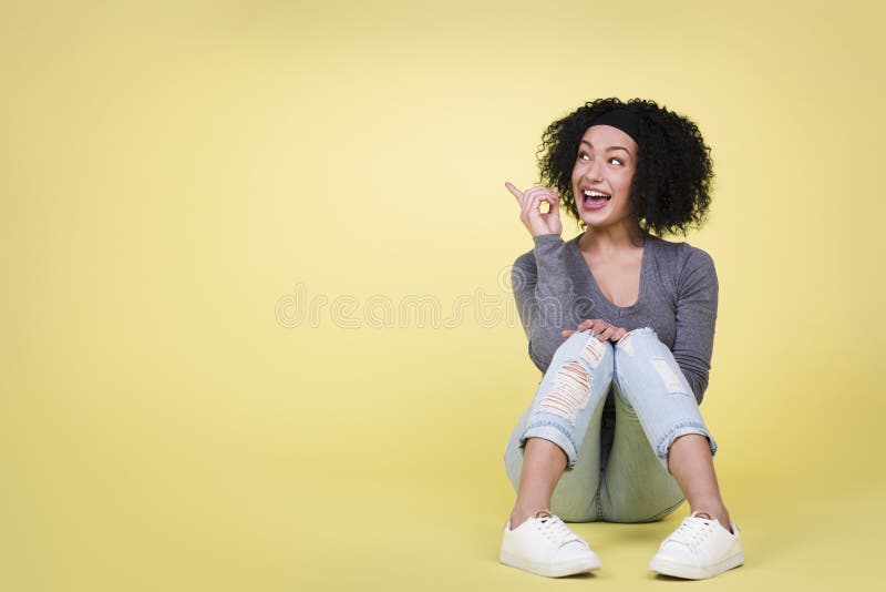 Excited woman pointing at copy-space