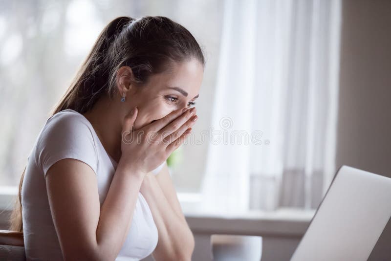 Excited woman reading unexpected good message on computer at home royalty free stock photography Excited woman reading unexpected good message on computer at home royalty free stock photography