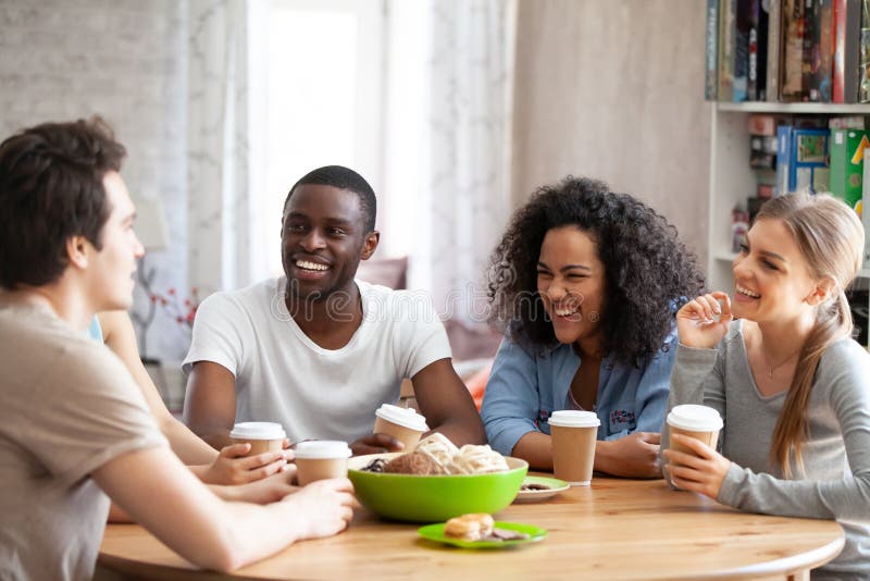 Excited young mixed race people listening to best friends joke. stock photo Excited young mixed race people listening to best friends joke. stock photo