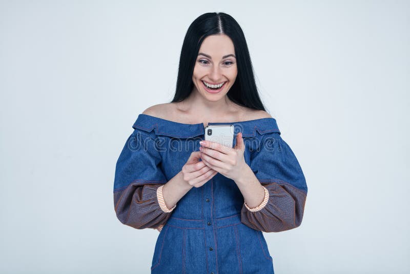 Excited young woman amazed by unbelievable shopping mobile app sale message looking at smartphone, euphoric girl winner holding royalty free stock photography Excited young woman amazed by unbelievable shopping mobile app sale message looking at smartphone, euphoric girl winner holding royalty free stock photography