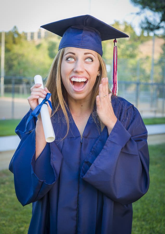 Excited Young Woman Holding Diploma in Cap and Gown royalty free stock photography Excited Young Woman Holding Diploma in Cap and Gown royalty free stock photography