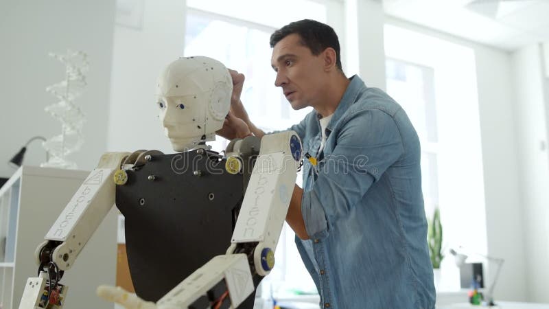 Professional engineer working on robot construction stock footage