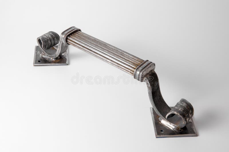 Exclusive door handle made of blacksmith. Forged, handmade handle. Close-up view. Forge production. Architectural detail stock images