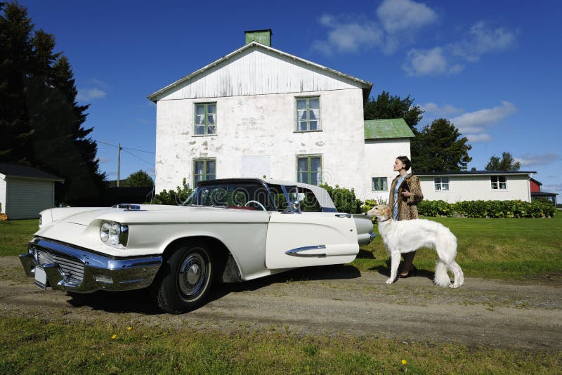 Exclusive woman with dog and car