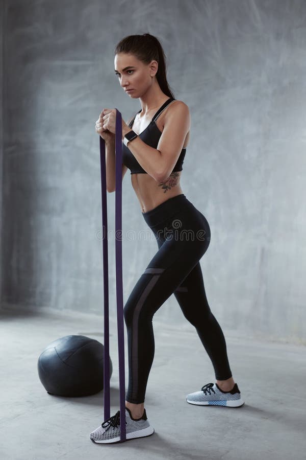 Fitness Exercise. Sports Woman Exercising With Resistance Band In Fashion Clothes, Loop Workout. High Resolution. Fitness Exercise. Sports Woman Exercising With Resistance Band In Fashion Clothes, Loop Workout. High Resolution