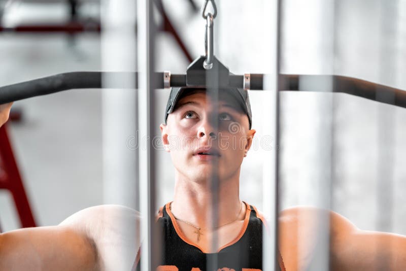 Exercise of the Back Muscles by Pulling the Pulley on the Strength