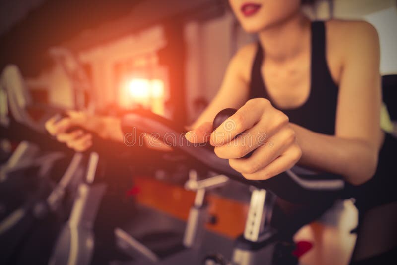 Exercise bike cardio workout at fitness gym stock photos Exercise bike cardio workout at fitness gym stock photos