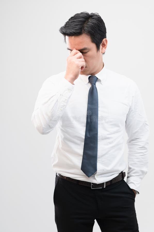Exhausted Asian Worker Squeezing between the Eyebrows To Try Relaxing