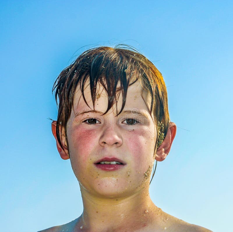 Exhausted boy after swimming at the beach