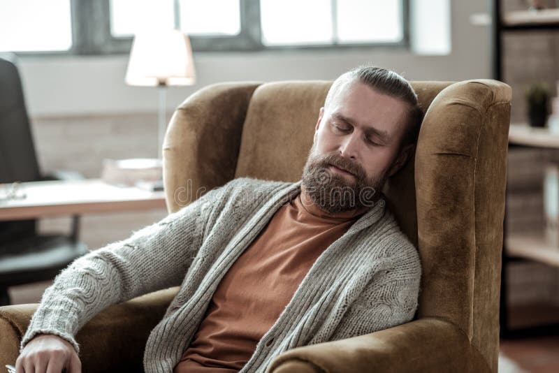 Exhausted counselor falling asleep in his armchair at work royalty free stock photos Exhausted counselor falling asleep in his armchair at work royalty free stock photos