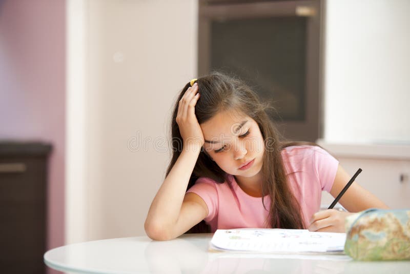 Exhausted little girl studying