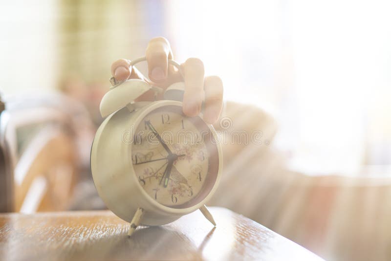 Exhausted sleepy person turn off white alarm clock at morning b stock photo Exhausted sleepy person turn off white alarm clock at morning b stock photo