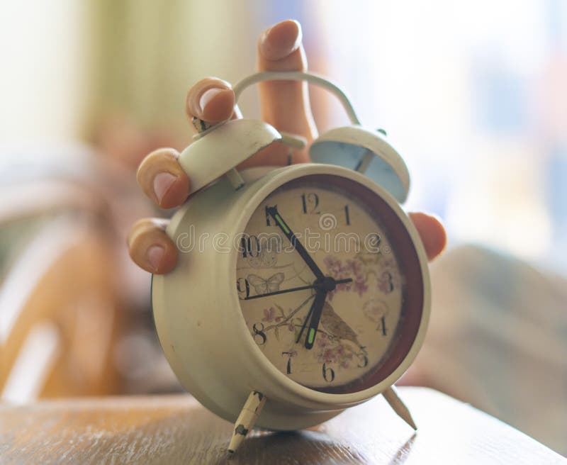 Exhausted sleepy person turn off white alarm clock at morning b stock photo Exhausted sleepy person turn off white alarm clock at morning b stock photo