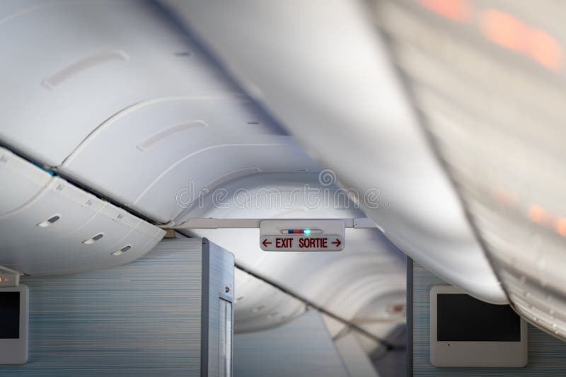 Exit sign in passenger airplane stock image