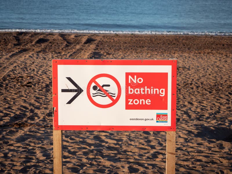 Exmouth, UK - August 03 2020: No bathing zone sign on the beach