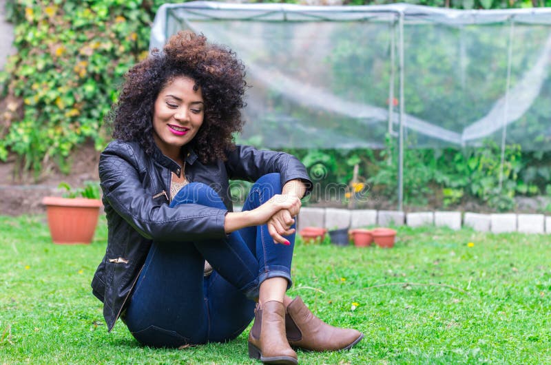 Exotic beautiful young girl relaxing in the garden