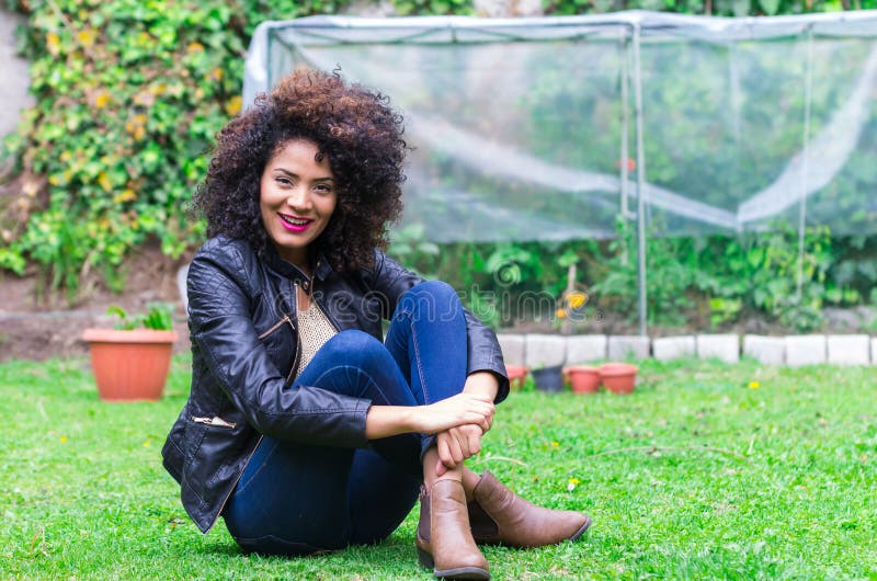 Exotic beautiful young girl relaxing in the garden