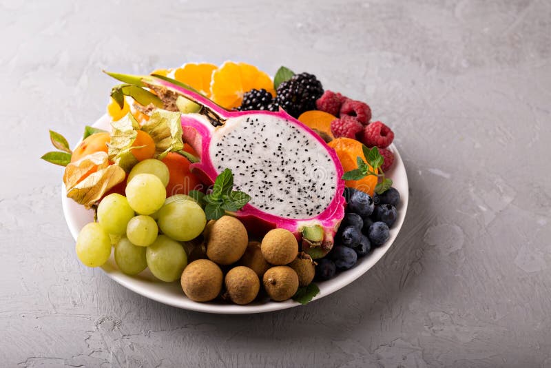 Exotic tropical fruits with dragon fruit, longan, maracuya on a plate. Raspberry basket stock images, royalty-free photos and pictures