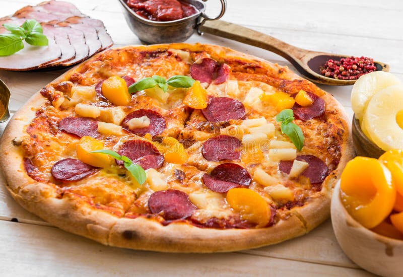 Exotic pizza with pineapple and peach