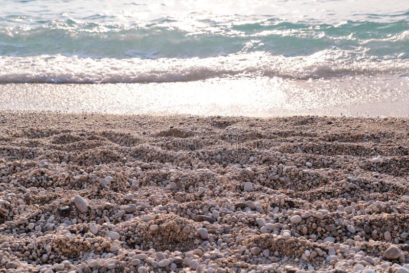 Exotic sandy beach, tropical blue mediterranean sea with waves and sea foam. Beautiful natural environment, panorama, landscape.