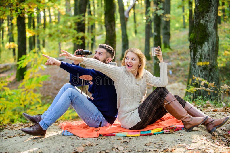 Expedition concept. couple in love relax in autumn forest with tea or coffee. Family picnic. camping and hiking stock photography Expedition concept. couple in love relax in autumn forest with tea or coffee. Family picnic. camping and hiking stock photography
