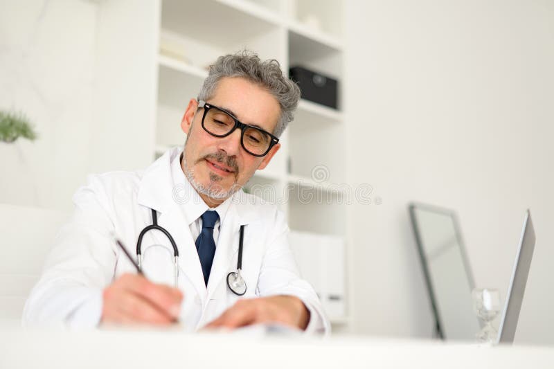Experienced confident senior doctor with grey hair stock images