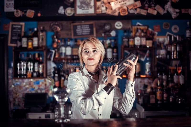 Experienced Girl Barman is Pouring a Drink while Standing Near the Bar ...