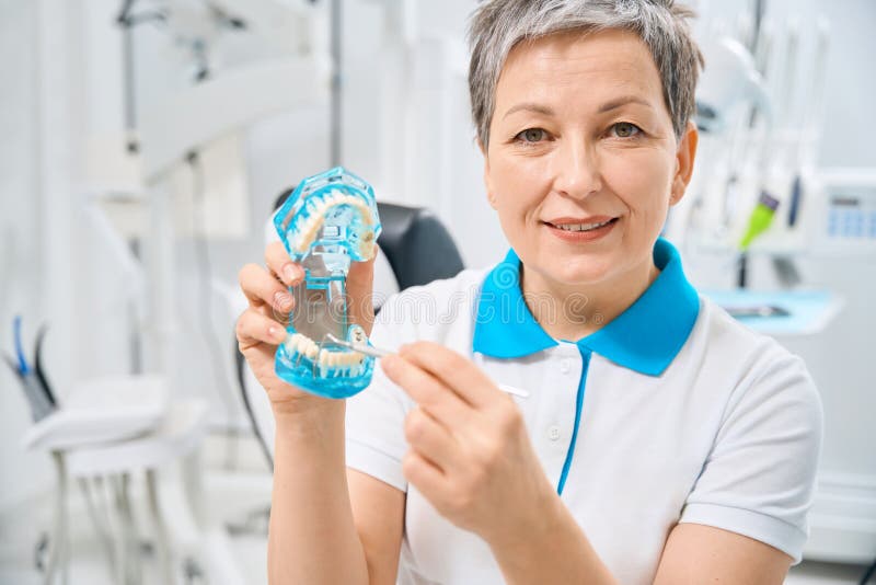 Experienced Lady Oral Surgeon Looking at Camera with Confident Face