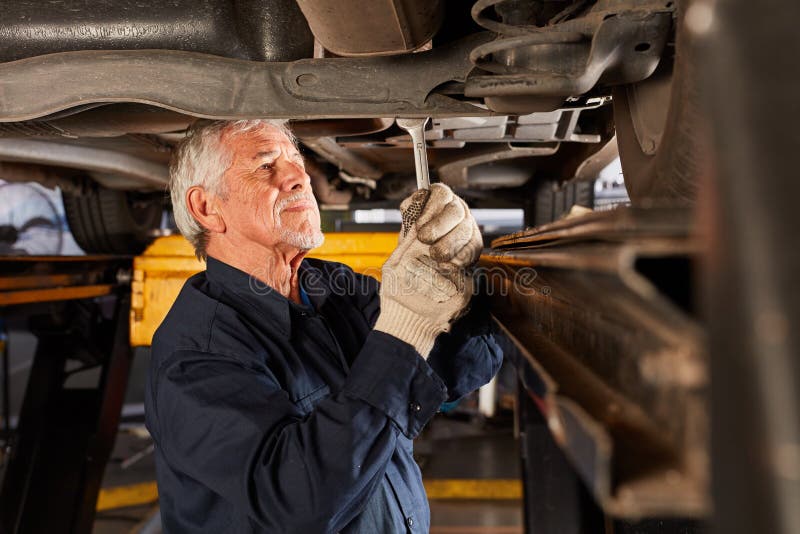 Experienced Mechatronics Engineer In Car Repair Stock Photo - ExperienceD Mechatronics Engineer Car Repair Technician Inspection UnDer Lift 173929832