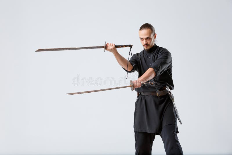 A Man, In A Black Kimono Is Practicing Martial Arts Technique With A Long  Bamboo Fighting Stick. Stock Photo, Picture and Royalty Free Image. Image  91980191.