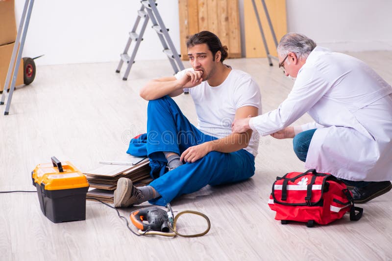 Experienced Paramedic Helping Workman Bitten by Snake Stock Photo