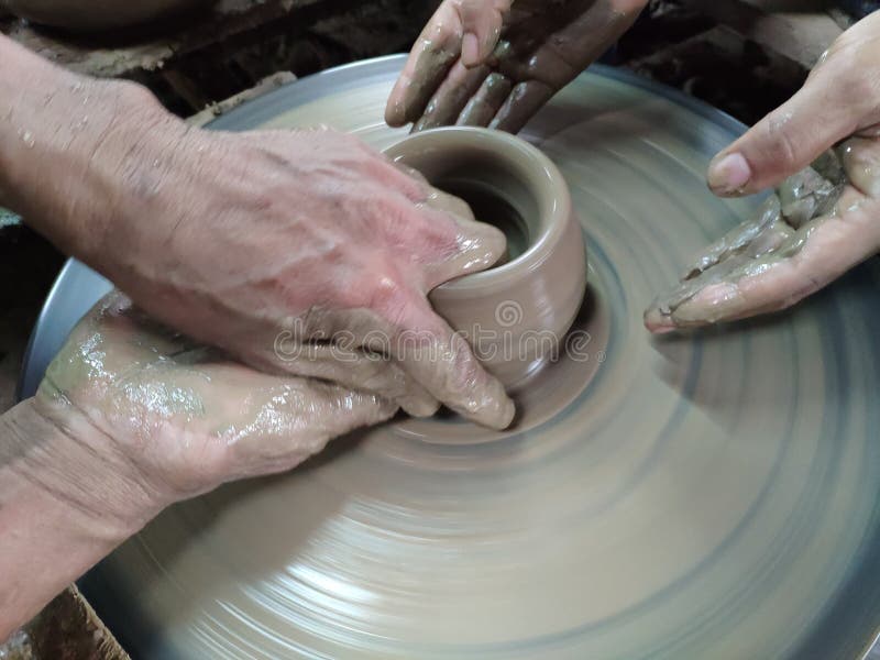 The Hands are sculpting the clay into the desired shape. Is one of the process of making pottery royalty free stock images