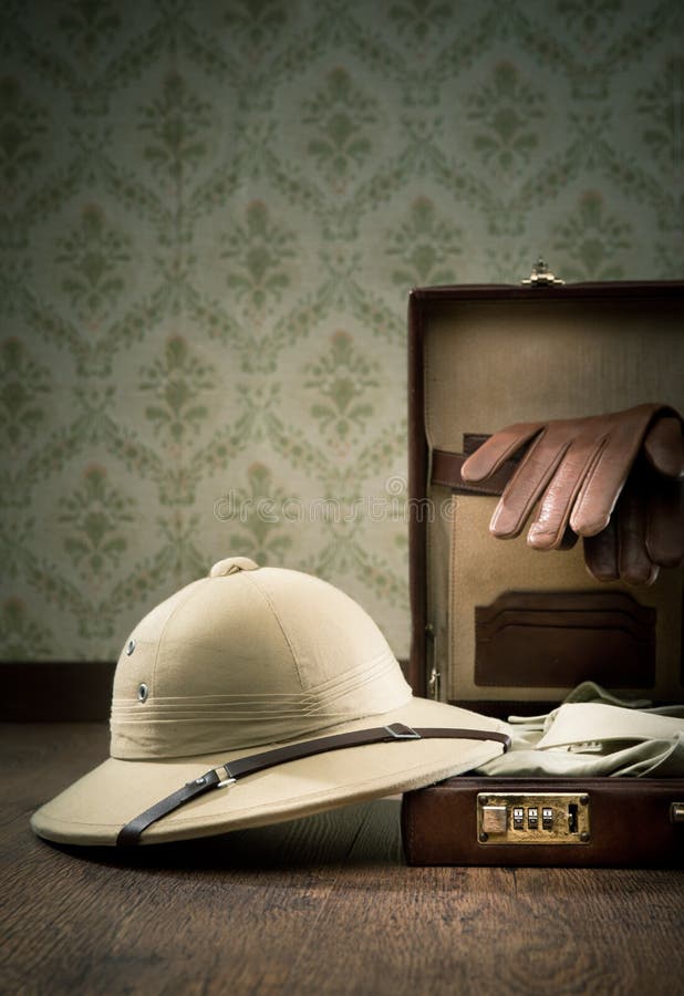 Explorer packing with open leather briefcase, pith hat, leather gloves on wooden surface. Adventurer adventure stock images, royalty-free photos and pictures