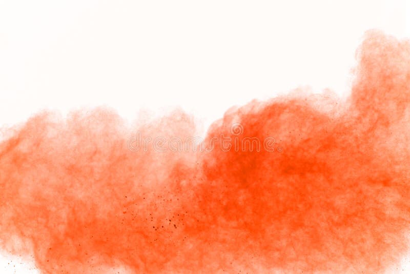 The explosion of orange powder. Freeze motion of orange powder exploding on white background. royalty free stock images