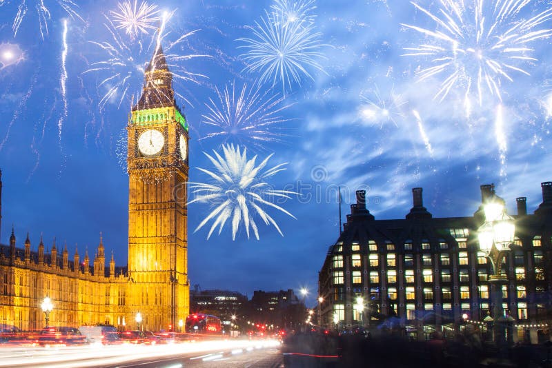 explosive fireworks display fills the sky around Big Ben. New Year& x27;s Eve celebration in the city