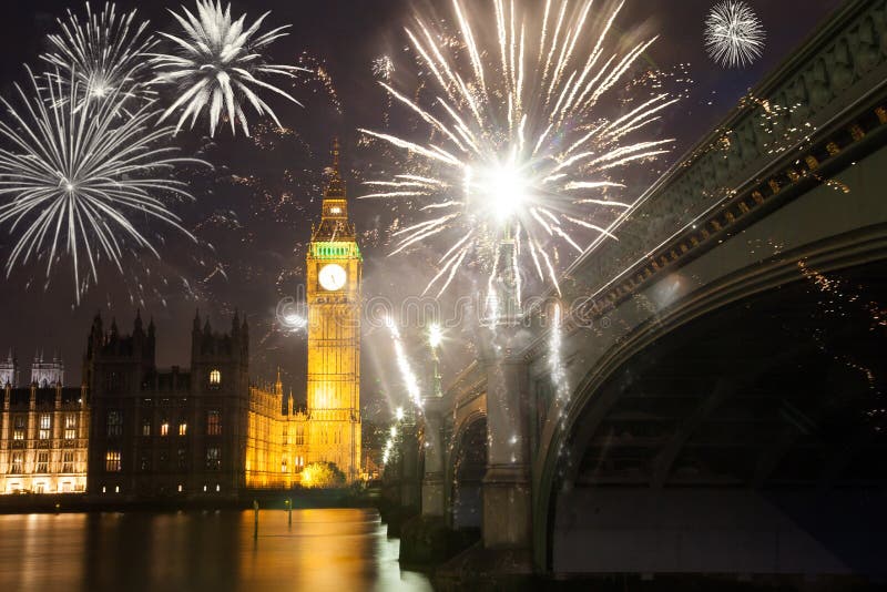 explosive fireworks display fills the sky around Big Ben. New Year& x27;s Eve celebration in the city