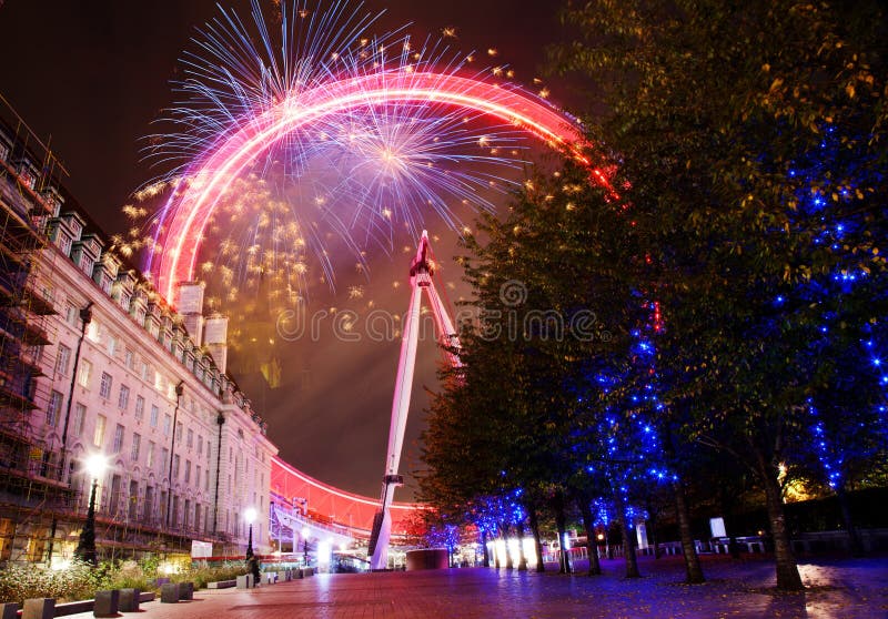 explosive fireworks display fills the sky around London eye. New Year& x27;s Eve celebration in the city