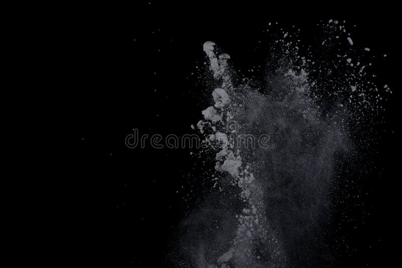 White powder explosion on black background. Dust splatted isolated. Paint Holi. White powder explosion on black background. Dust splatted isolated. Paint Holi.