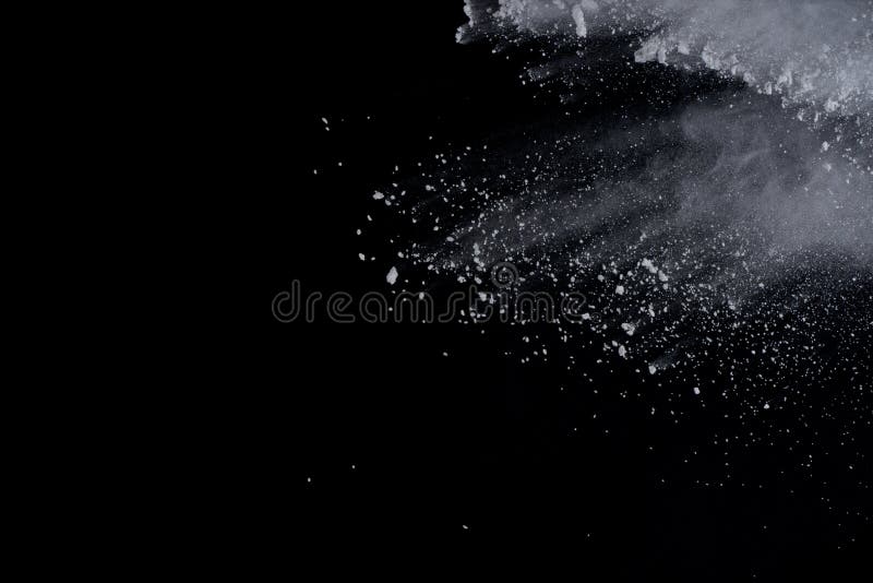 White powder explosion on black background. Dust splatted isolated. Paint Holi. White powder explosion on black background. Dust splatted isolated. Paint Holi.